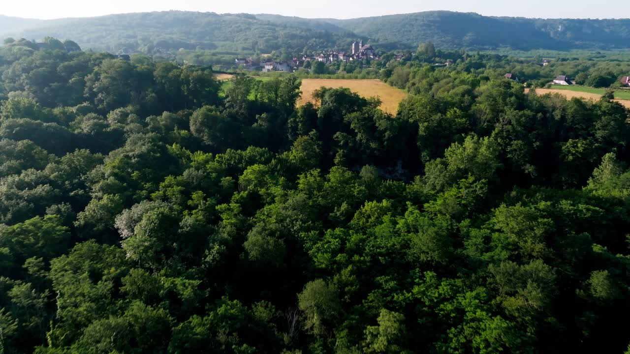 Drone shot over the forest and discovery of the village of Floirac in Lot, France