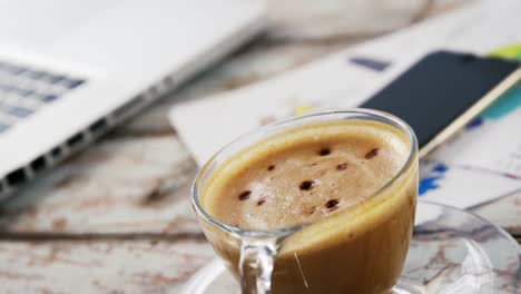 coffee cup on wooden plank