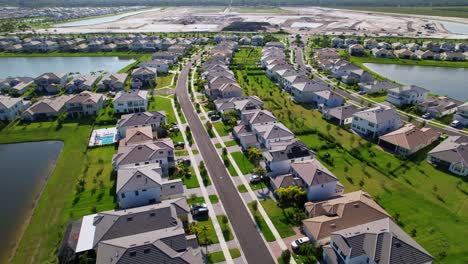 aerial: west palm beach residential area with lakes during the day in florida, usa, push in drone shot