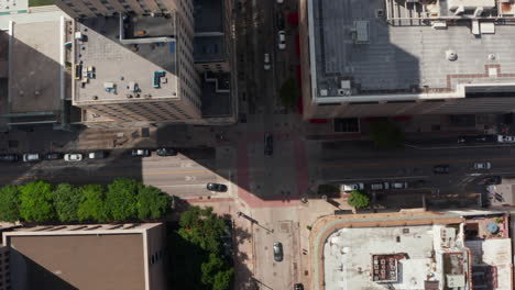 Aerial-birds-eye-overhead-top-down-view-of-multi-lane-downtown-street-crossing.-Cars-driving-on-road-in-town.-Dallas,-Texas,-US