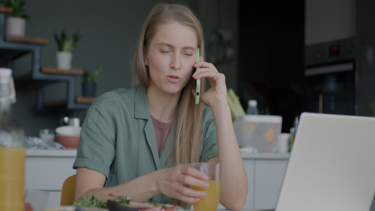 Woman working from home during breakfast
