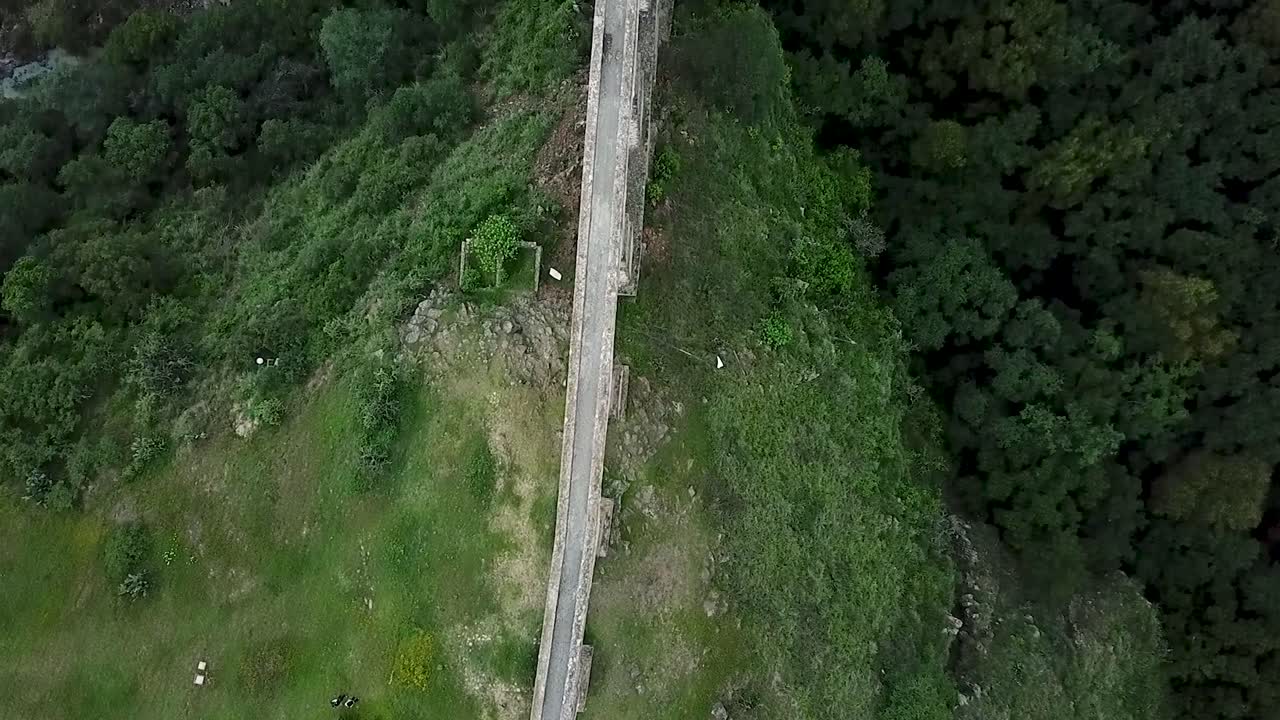 Drone shot following the path of the water of the viceregal aqueduct rotating with a perspective of "Arcos del Sitio" in Tepotzotlan, State of Mexico, Mexico