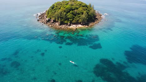 a serene aerial view of a tropical island surrounded by crystal-clear turquoise waters, showcasing vibrant underwater scenery and lush greenery under a bright sky