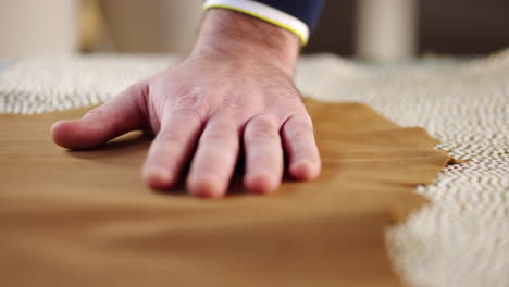 close-up of a hand touching leather fabric