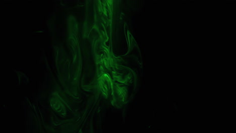 Green-smoke-on-black-background,-abstract