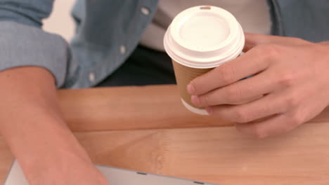 Creative-businessman-drinking-coffee-at-his-desk