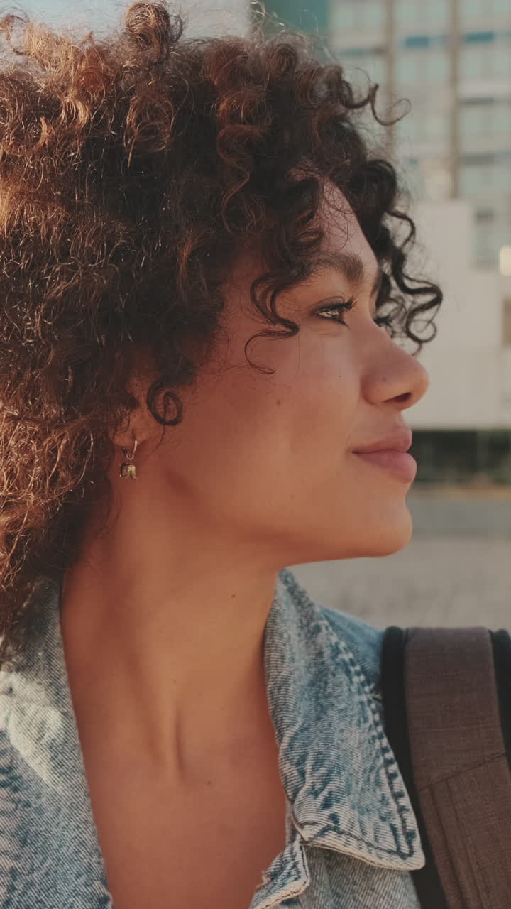 Portrait of a Smiling Woman with Curly Hair in Denim Jacket