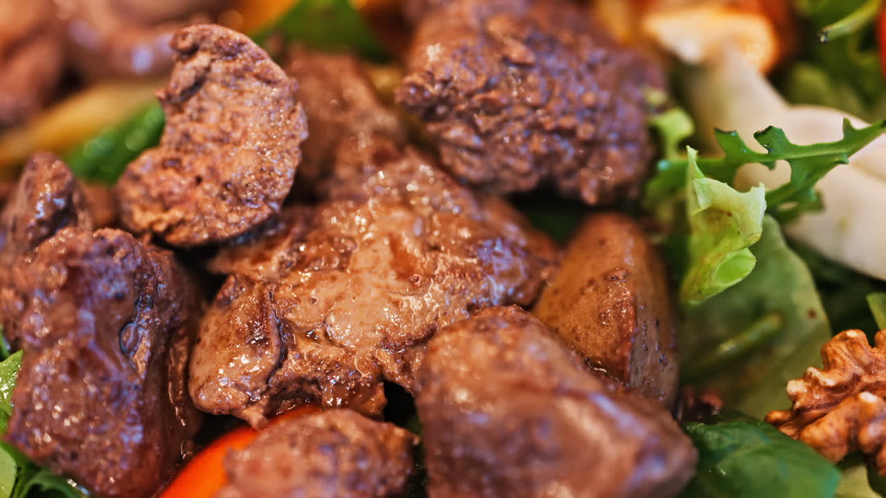 Close up of a salad with pork meat and nuts