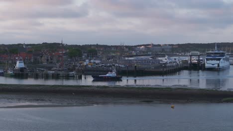 rescue boat at harbour of west terschelling during sunrise, aerial