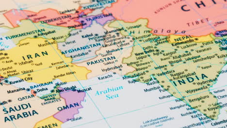 close-up of the country word pakistan and iran on a world map with the detailed name of the capital city