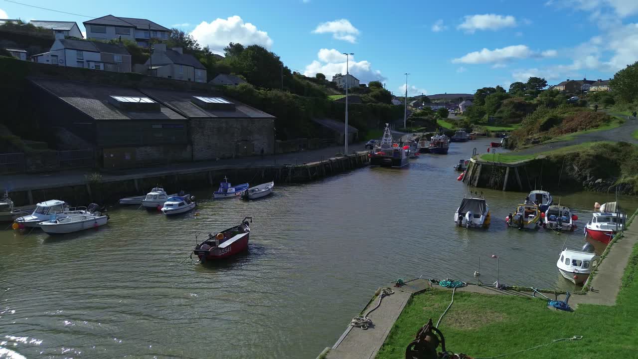 Amlwch harbour aerial view over boats moored on sunny sparkling Welsh town port waterway