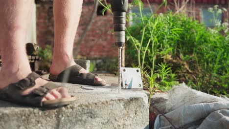 drilling hole on concrete with corded electric drill