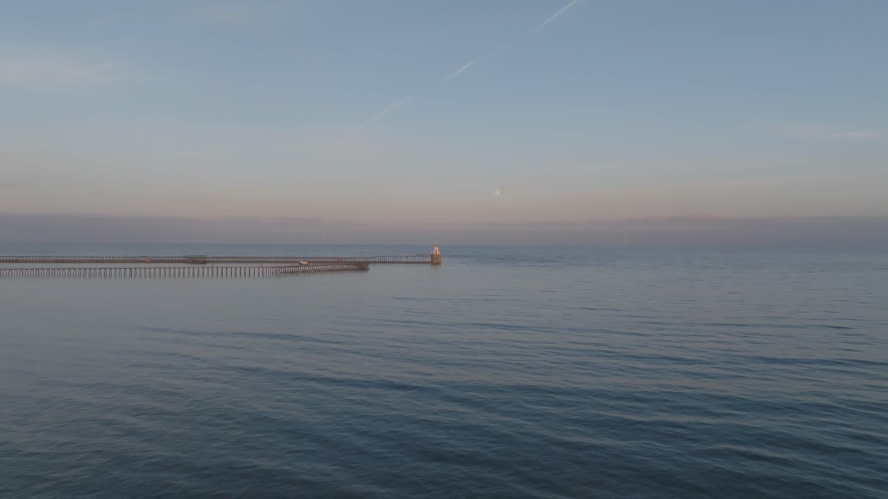 Experience the transition from vibrant sunset to moonlit calm over Blyth Harbour in stunning aerial detail.
