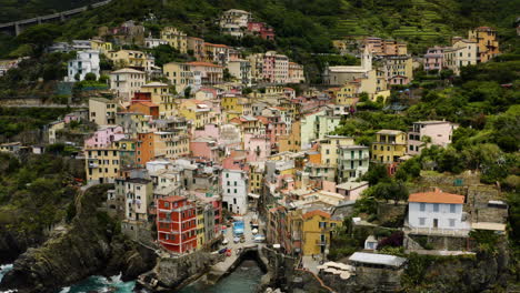 pullback shot revealing village of riomaggiore in italy