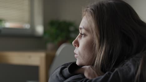 caucasian young woman looking away with depression.