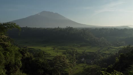 sunrise over indonesian rice terraces and volcano