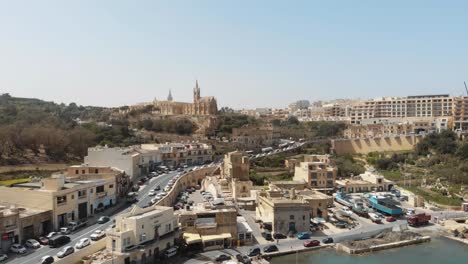 aerial push in shot towards church of the madonna of lourdes in gozo malta