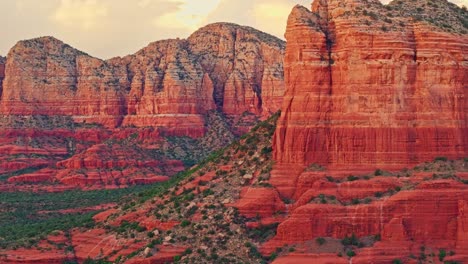 telephoto trucking pan across desert alpenglow on weathered red rock canyon in the southwest