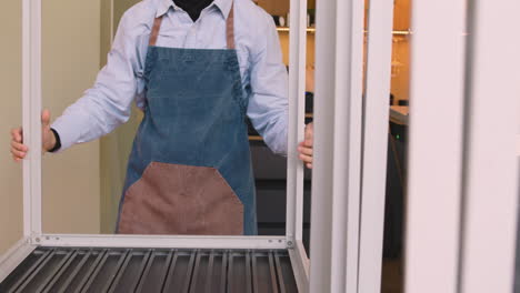 waiter cleaning table after closing coffee shop