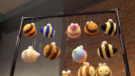 colorful yarn bees are hanging on a string