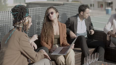 slow motion of serious coworkers talking during outdoor party