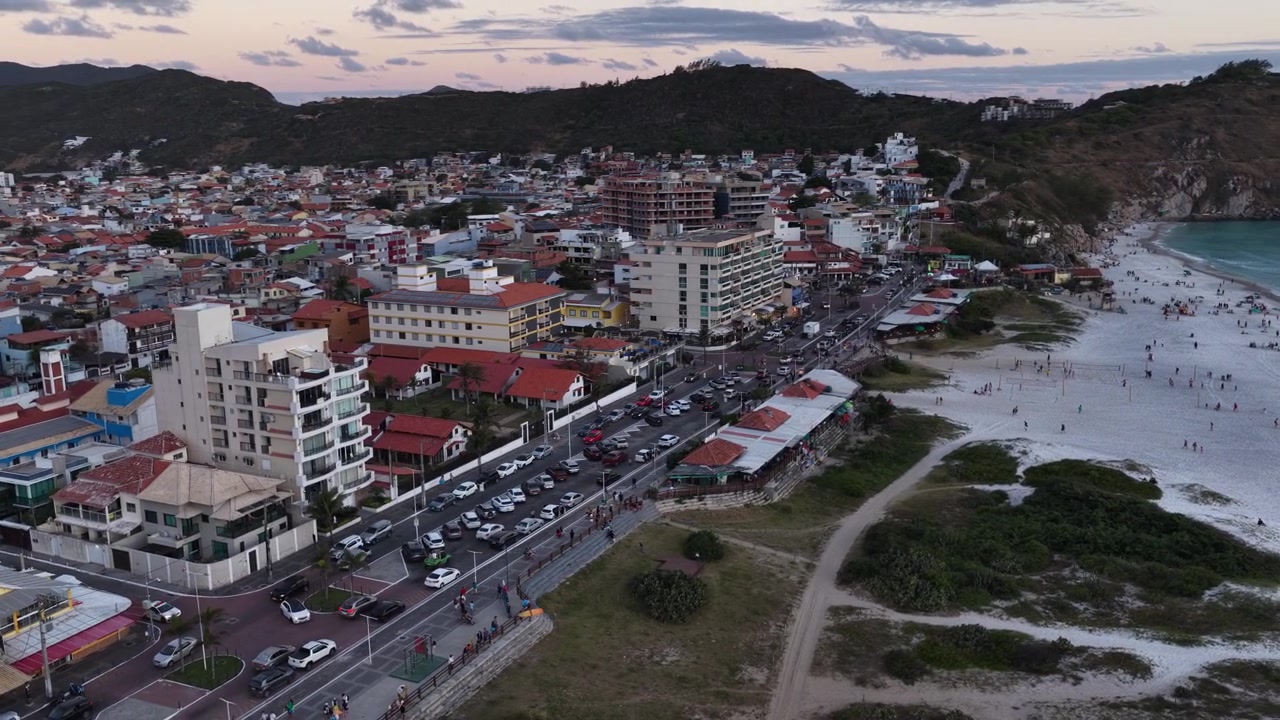 Aerial view of Arraial do Cabo town, beach and coastline at dusk, Brazil