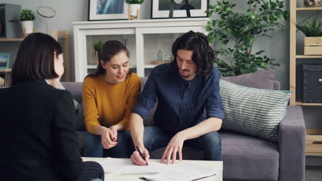 couple signing house purchase agreement with real estate agent