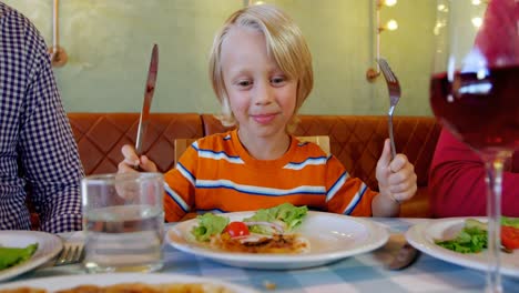 family having meal together in restaurant 4k