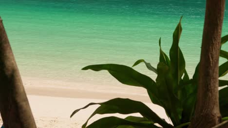 close up of turquoise sea waves and white sand tropical beach in thailand