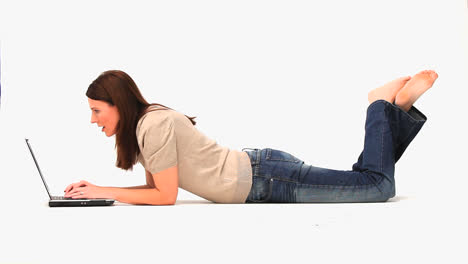 casual woman laying with a laptop