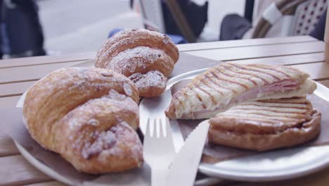 Close-Up-of-Croissants-and-a-Croque-Monsieur-Sandwich-at-a-Cafe