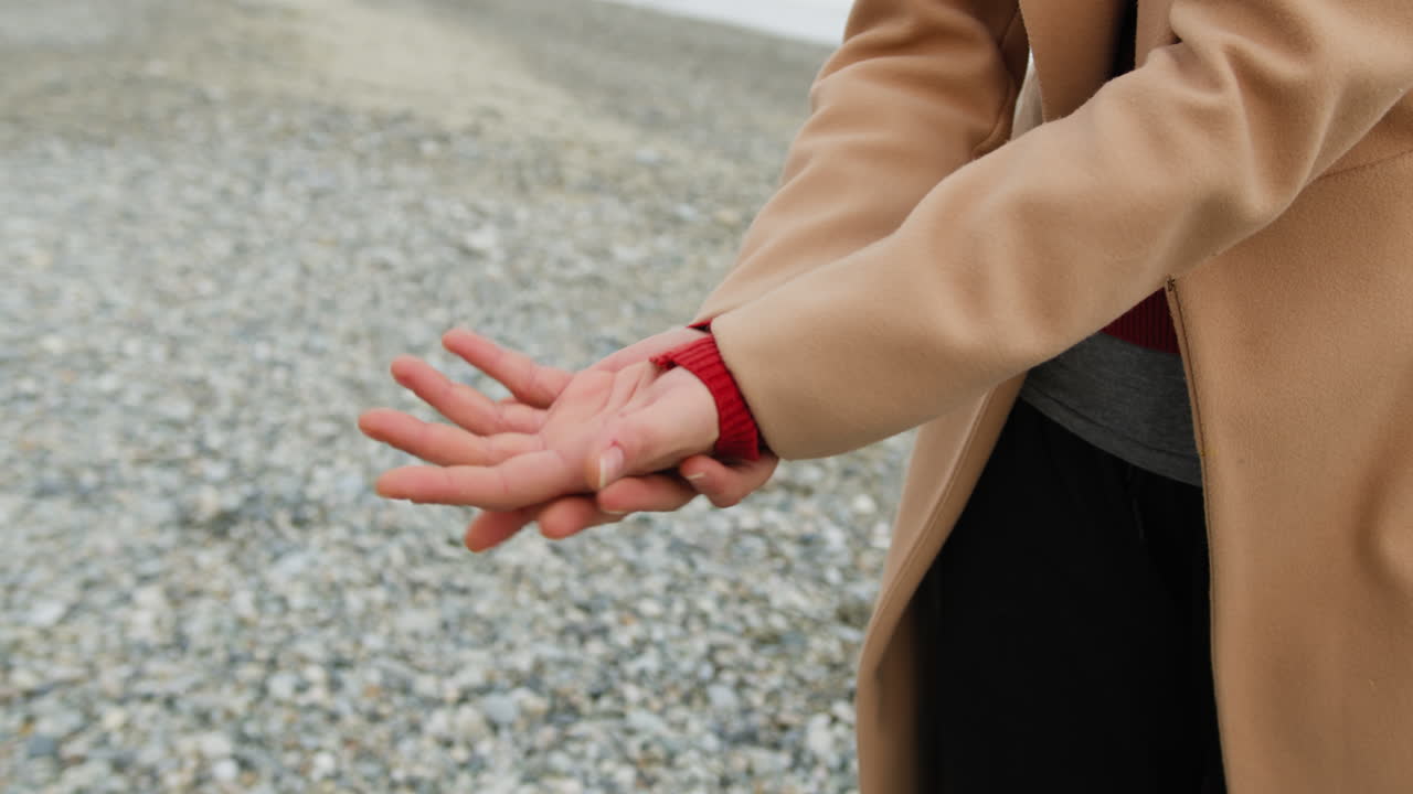 Hands Of A Woman Move Harmoniously On The Beach Close Up