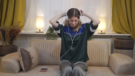 happy young woman listening to music with headphones.