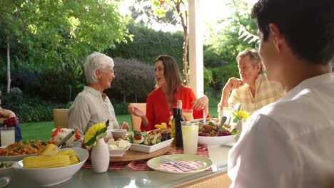 family eating outside together in summer