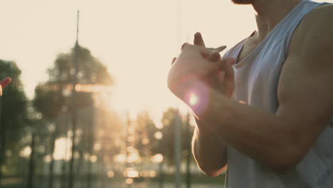 Close-Up-Of-A-Concentrated-Sportsman-Stretching-Wrists-And-Hands