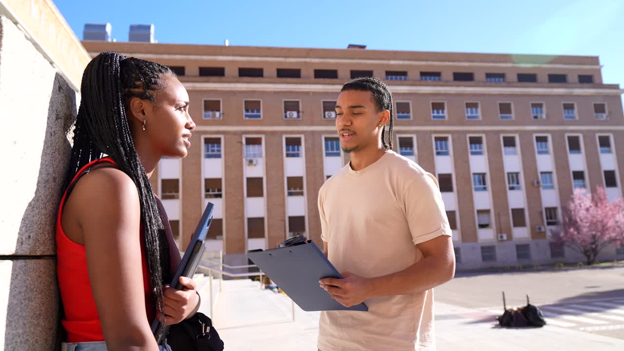 Two Young Students Talking and Smiling on University Campus