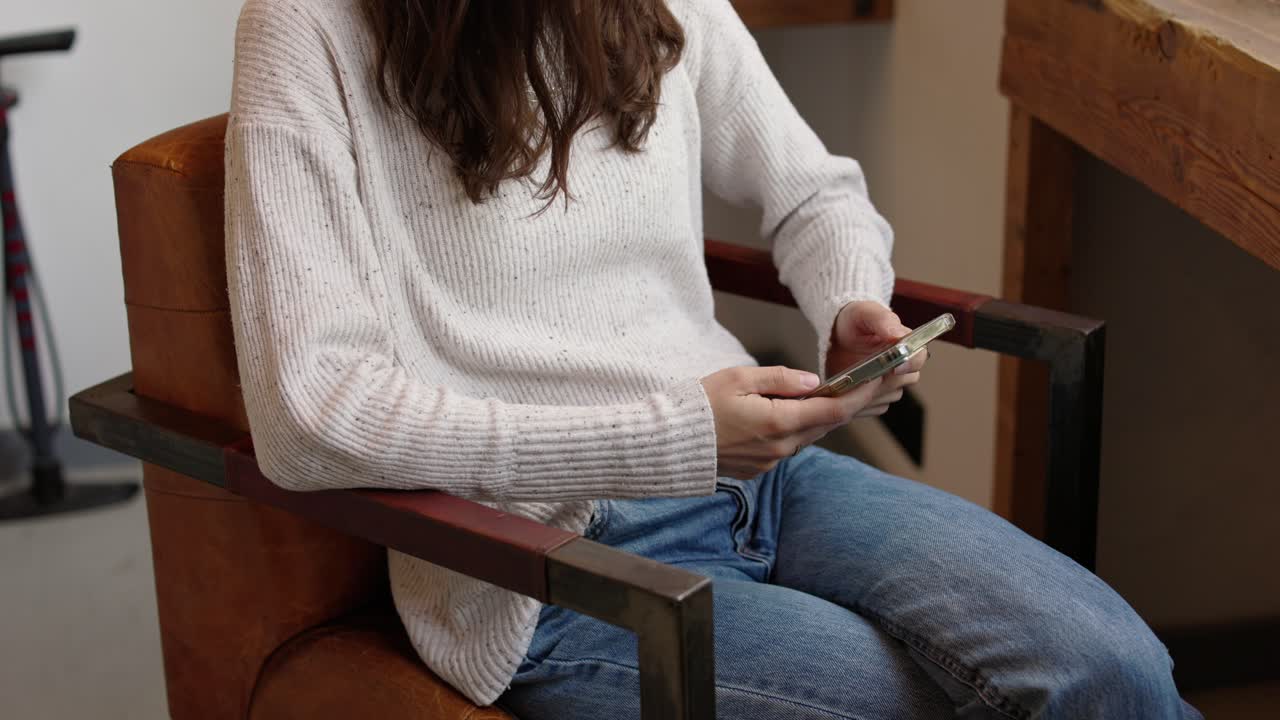 Woman using smartphone in a chair