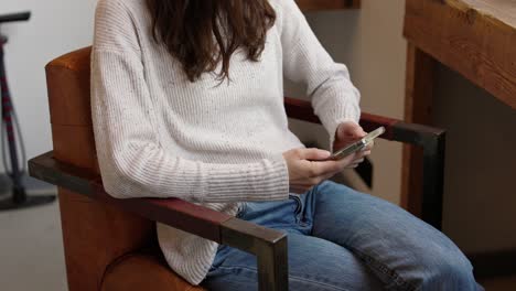 woman using smartphone in a chair