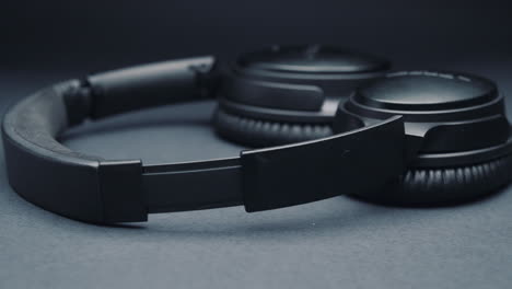 headphones on a dark background, moving the camera from right to left