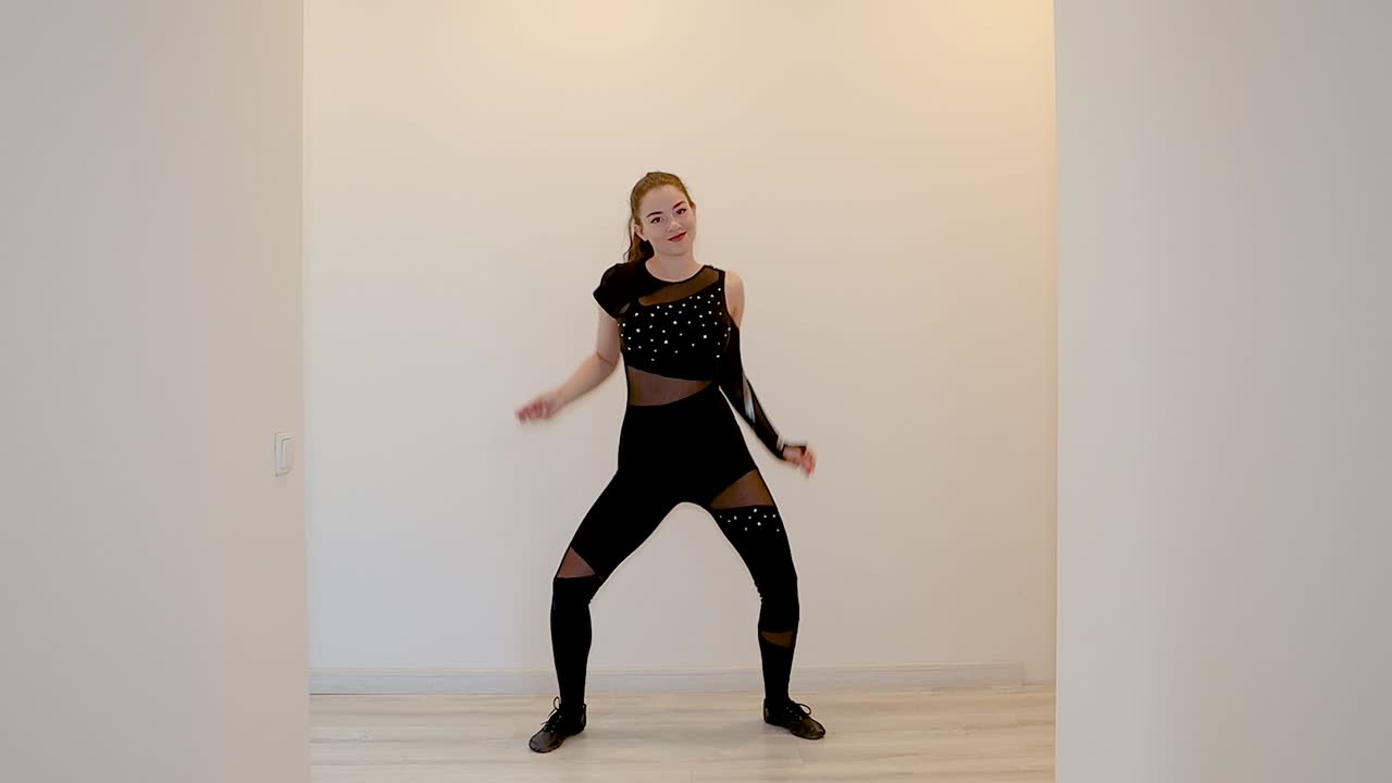 Slow motion clip of a dancer teaching an online dance class from home