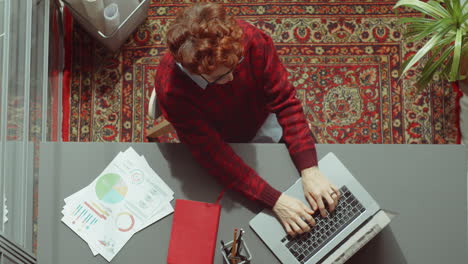 top view of businesswoman posing for camera at office desk