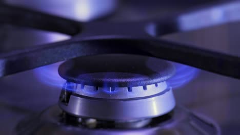 gas burner on the kitchen stove. fire on the stove close up video. economic crisis of natural gas in household .