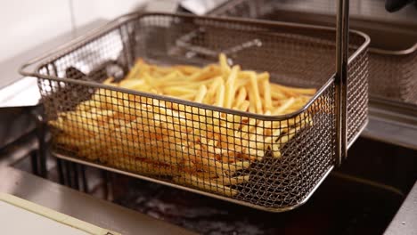 french fries being fried in a deep fryer