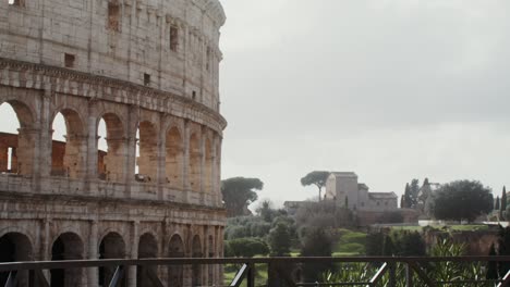 a woman comes to the observation deck of the colosseum and takes a photo