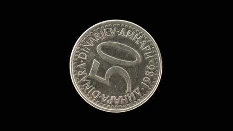 yugoslavia 1986 50 dinara coin reverse with large denomination and multilingual currency text rotating on black background