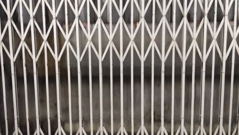 View-Through-Manual-Steel-Gate-Of-Vintage-Elevator-Ascending-In-Hong-Kong