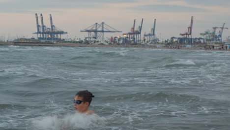 child having fun with sea waves