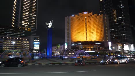 night illumination jakarta city downtown famous traffic street circle fountain panorama 4k indonesia