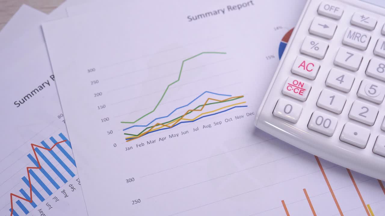 White calculator and report with chart and graph, concept of annual financial profit overview, banking and statistic, truck right, macro, close up