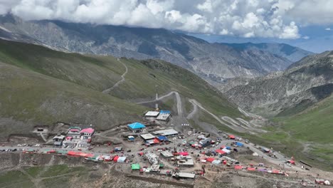 a drone retreats upwards over babusar pass, revealing the sweeping vistas and rugged terrain of this stunning mountain pass in northern pakistan